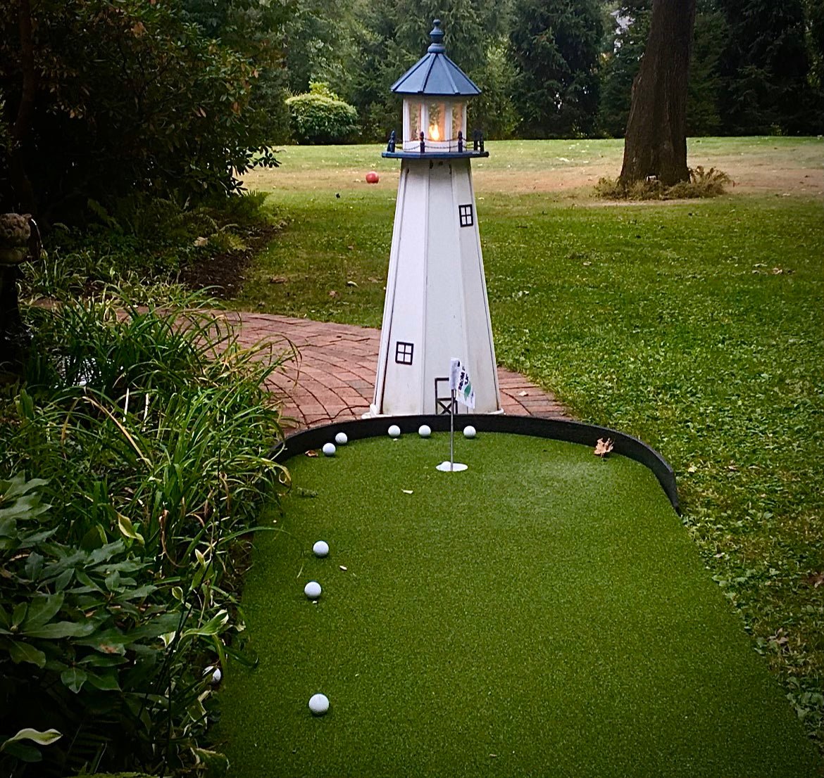 Mini golf green with lighthouse obstacle and golf balls - Big Moss Commander Bulk Turf for backyard putting course - ALLBGT