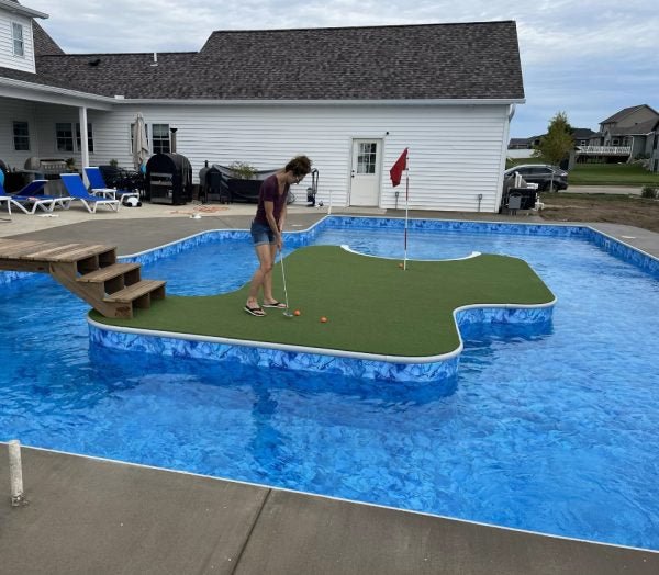 Custom floating putting green over residential pool - outdoor use of Big Moss Commander Bulk Turf with flag - ALLBGT
