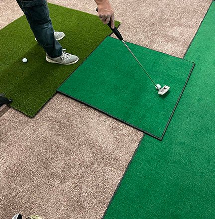 Golfer practicing on Big Moss C-Series DIY Kit Pro Golf Enclosure Kit with 9ft ceiling premium turf mat - ALLBGT