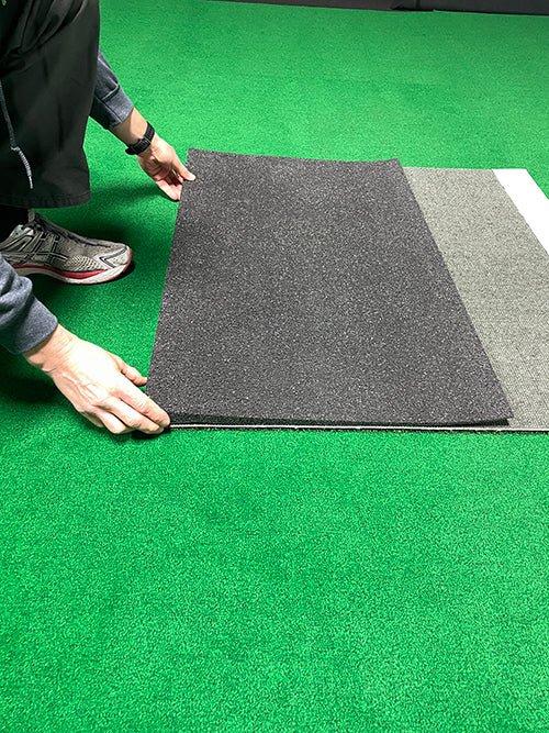 "Person assembling the Big Moss TL Ball Return Ramp - 3x3 Putting Green Accessory on green turf surface - ALLBGT"