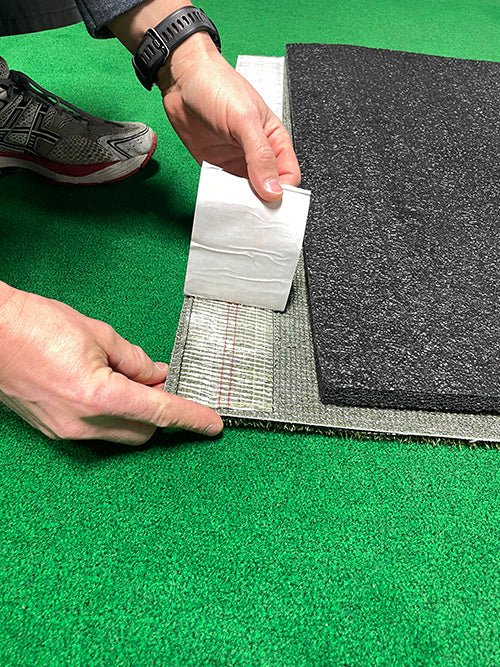 "Person aligning the Big Moss TL Ball Return Ramp - 3x3 Putting Green Accessory with putting mat during setup - ALLBGT"