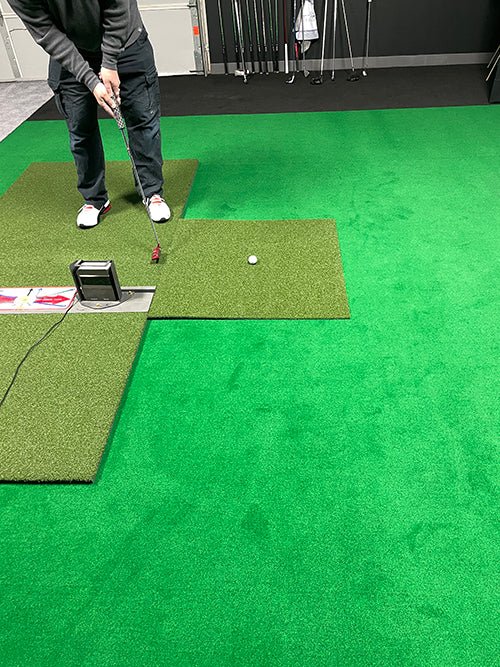 "Golfer testing the Big Moss TL Ball Return Ramp 3x3 Putting Green Accessory during indoor putting practice - ALLBGT"