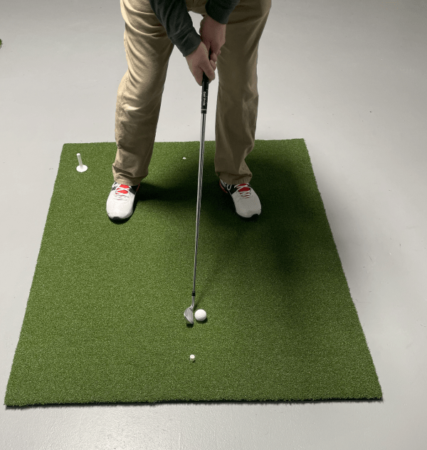 Full view of golfer standing on Big Moss True Launch Hitting Mat 4'x 5' during indoor golf session - durable design - ALLBGT