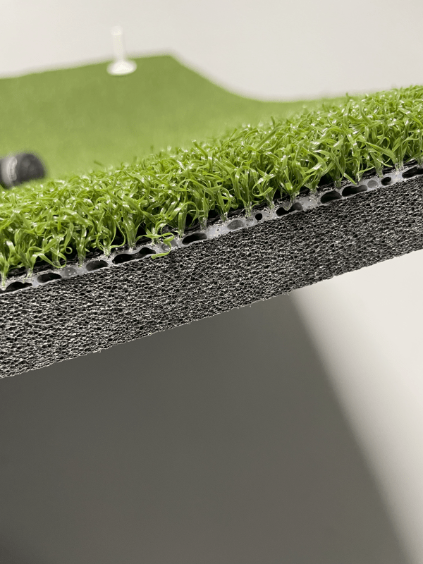 Close-up side view of Big Moss True Launch PLUS Hitting Mat 5'x10' showing layered foam padding and turf fibers - ALLBGT