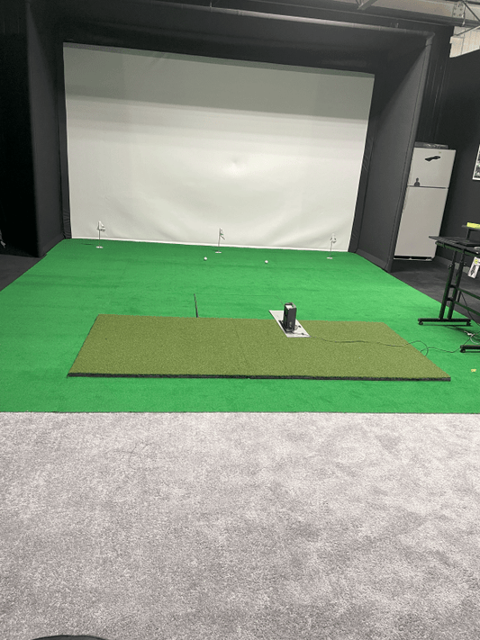 Indoor golf simulator setup featuring Big Moss True Launch PLUS 5'x10' hitting Mat on turf surface - ALLBGT