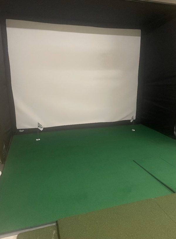Indoor golf simulator with Big Moss V2 Bulk Turf green and dual putting holes for precision practice. - ALLBGT