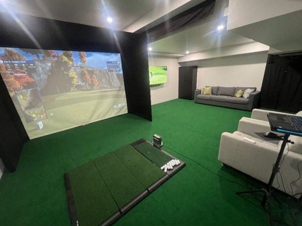 Indoor golf simulator room with Big Moss V2 Bulk Turf custom putting green and hitting mat setup - ALLBGT