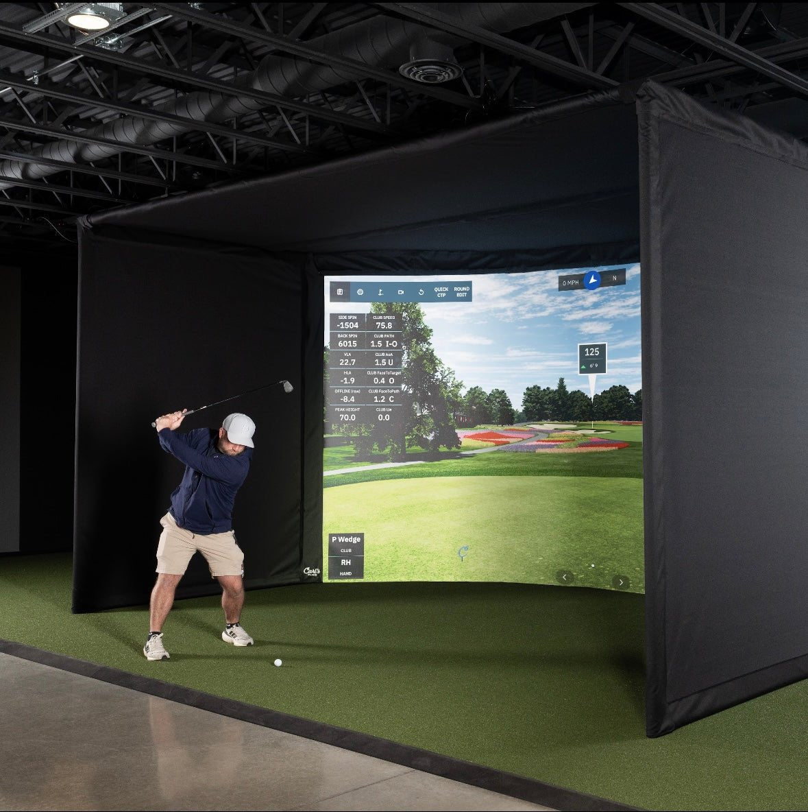 "Golfer practicing inside Carl’s Place Curved Golf Simulator Enclosure Kit with premium Screen - ALLBGT"