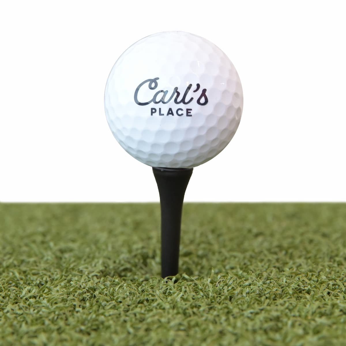 Carl’s Place golf ball on black driver tee for golf simulator turf setup - sturdy 50 pack design. - ALLBGT