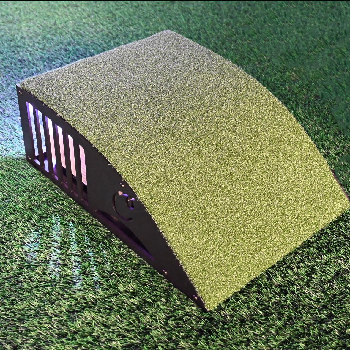 “Carl’s Place Floor-Mounted Projector Enclosure Kit placed on golf simulator turf for projector protection - ALLBGT.”