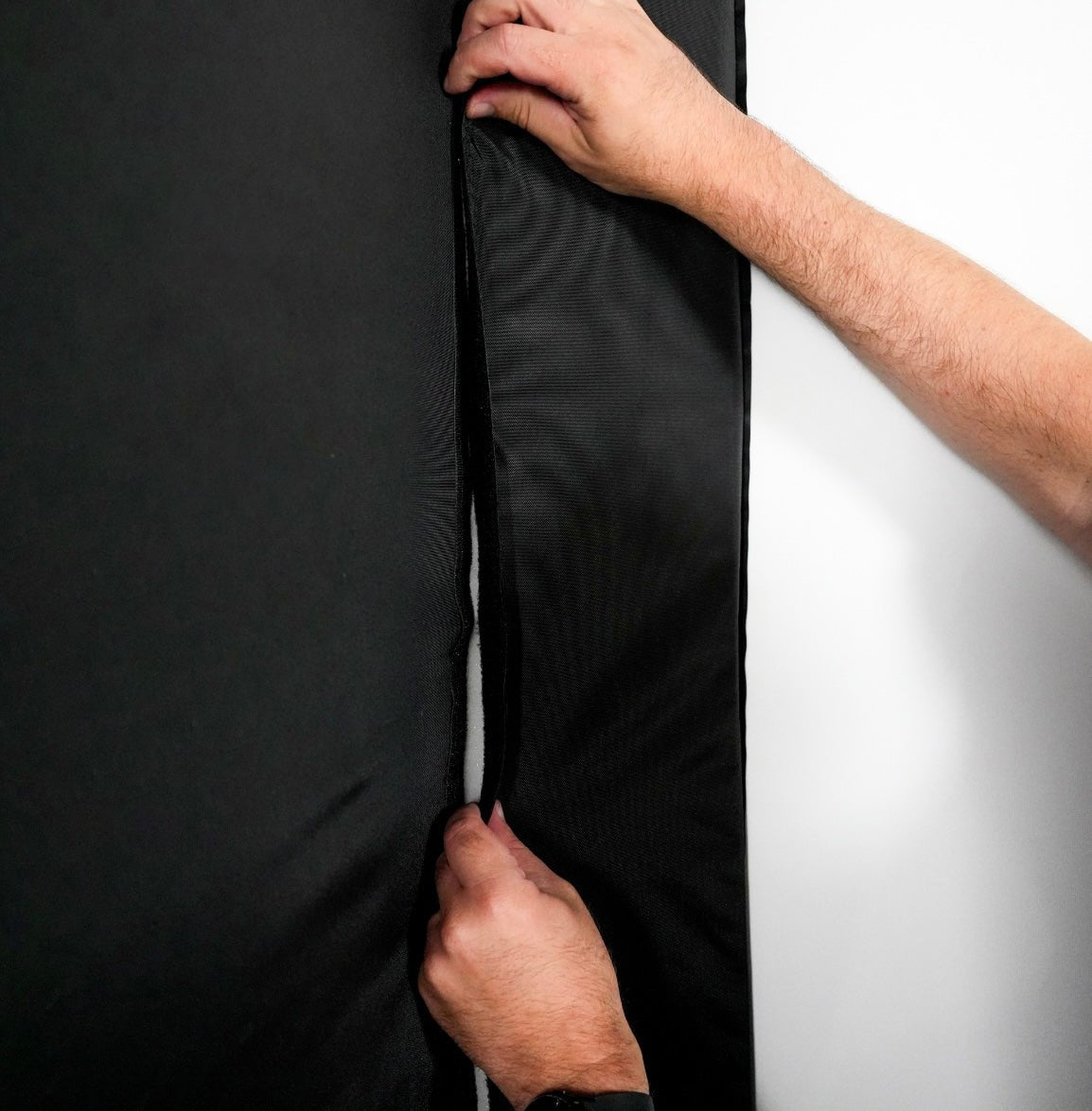 Hands fitting Carl’s Place Foam Insert into DIY Golf Simulator Enclosure frame 8x8 - ALLBGT