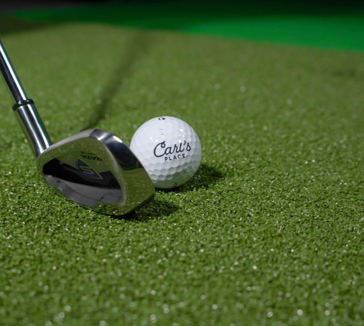 "Close-up of Carl’s Place HotShot Golf Mat System surface with golf club and ball - ALLBGT."