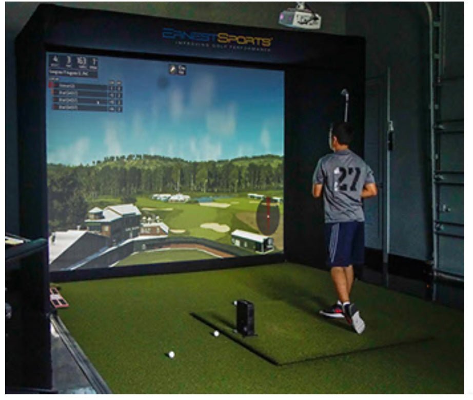 Golfer using Ernest Sports ES Tour Plus Launch Monitor 2.0 inside golf simulator setup for swing analysis - ALLBGT