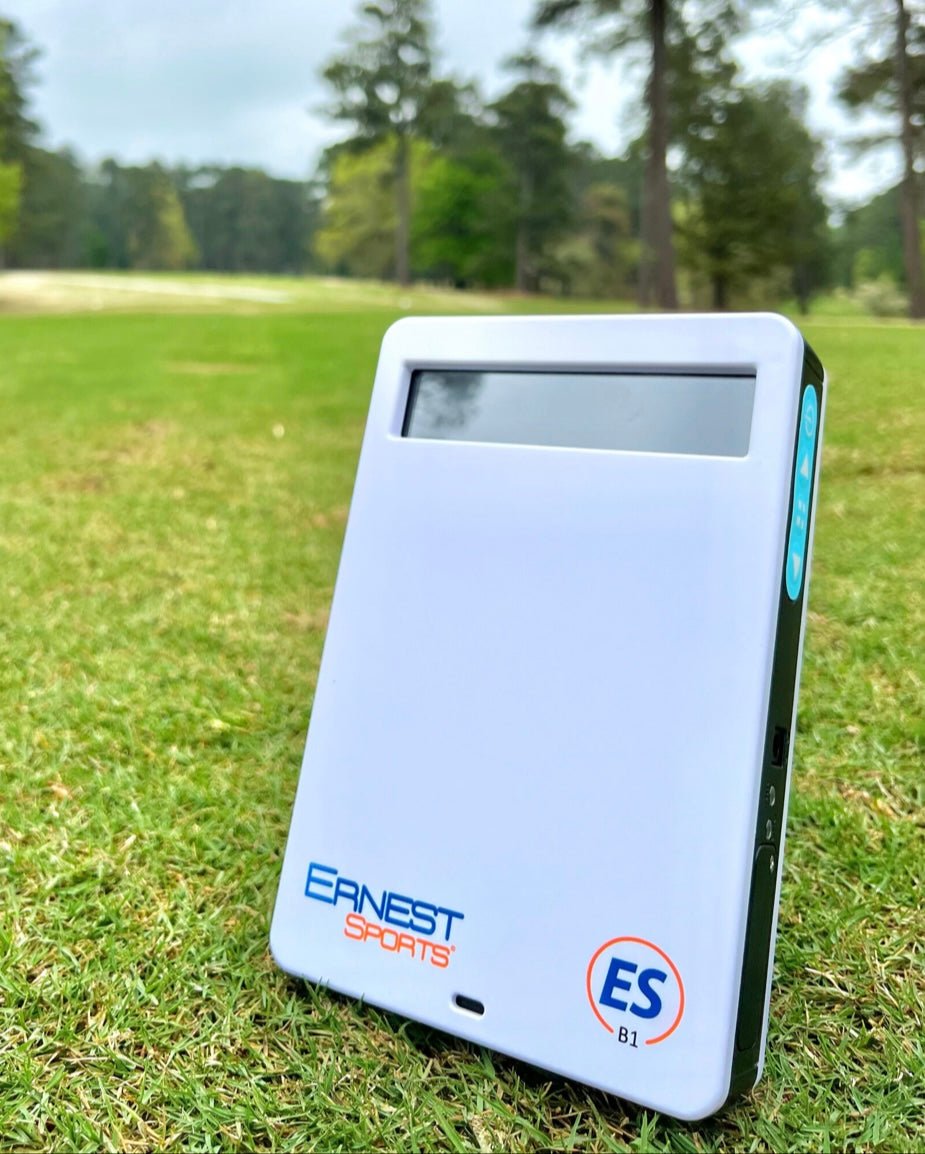 Ernest Sports ESB1 golf launch monitor on grass measuring swing data with clear outdoor background - ALLBGT