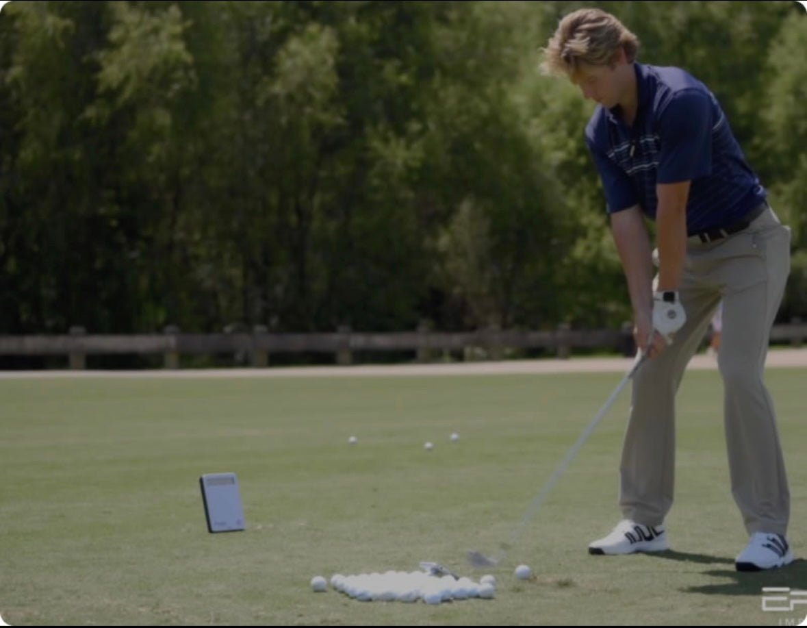 Golfer practicing on the range using Ernest Sports ESB1 golf launch monitor to track swing performance and accuracy - ALLBGT