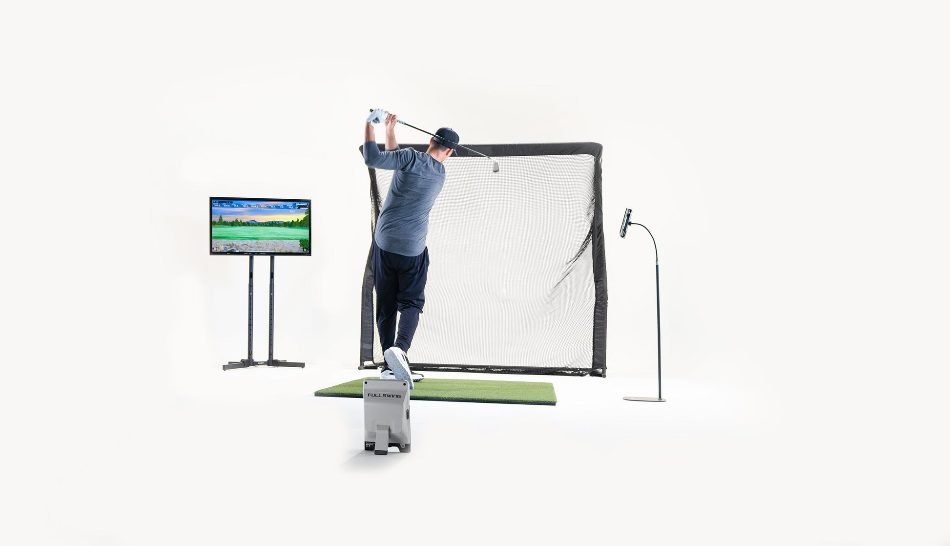"Golfer using Full Swing KIT Golf Launch Monitor and impact screen setup for indoor golf training - ALLBGT."