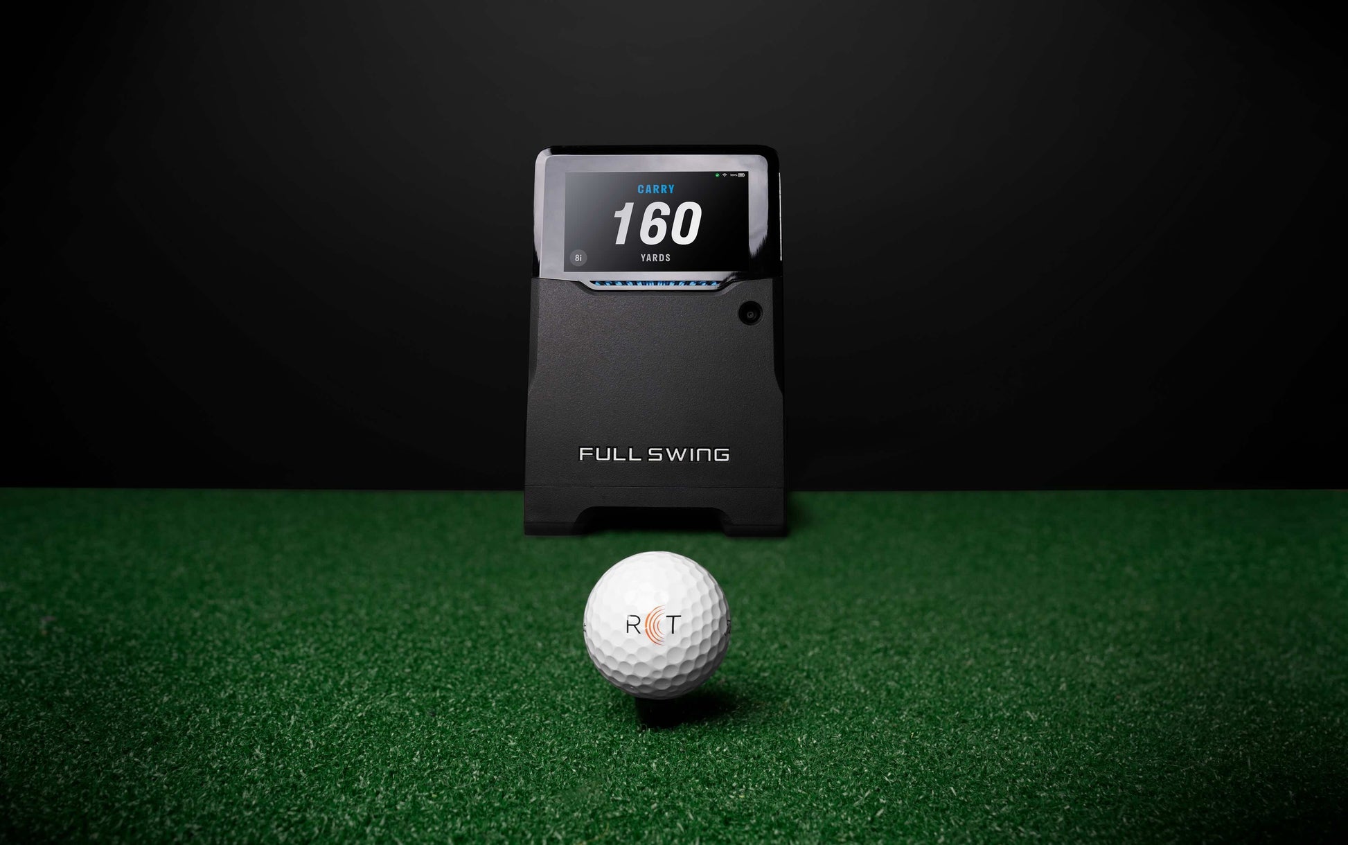 “Full Swing KIT Golf Launch Monitor with a golf ball in front it on turf -  ALLBGT.”
