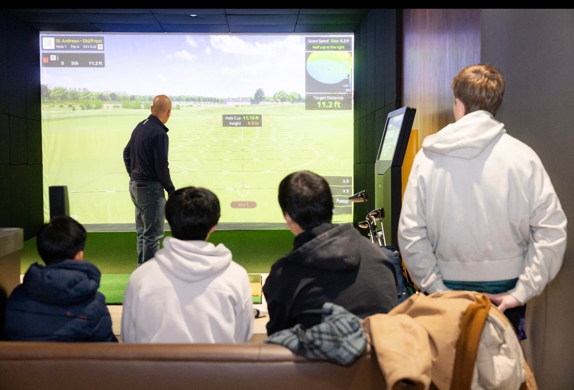 Golf VX T2 Simulator in use - instructor guiding players on virtual golf course screen - group golf training - ALLBGT