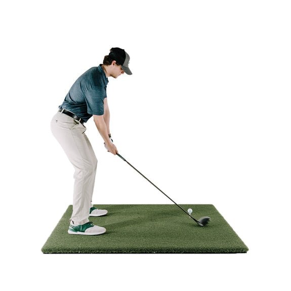 Person practicing golf swing on SIG fairway series golf mat with a white background