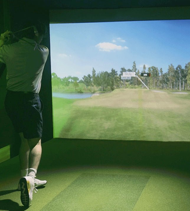 “Golfer swinging inside SimBooth Kit 1 Golf Simulator Enclosure with projected fairway inside indoor practice setup - ALLBGT”