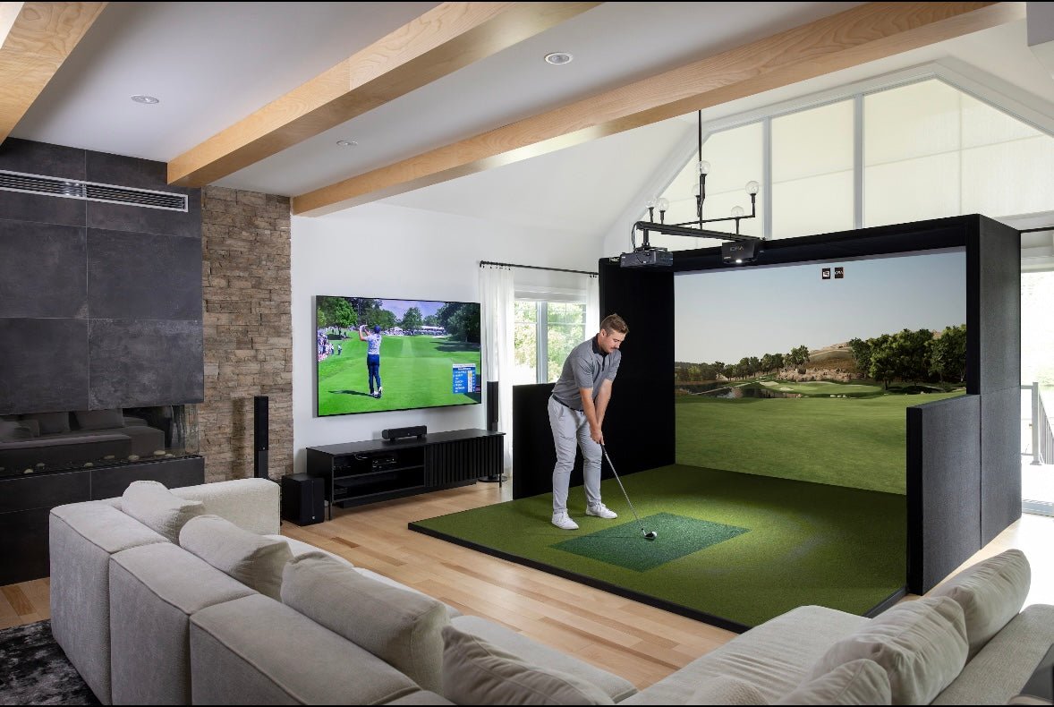 Golfer practicing swing inside SimBooth Kit 1 indoor simulator with projector and turf mat. - ALLBGT