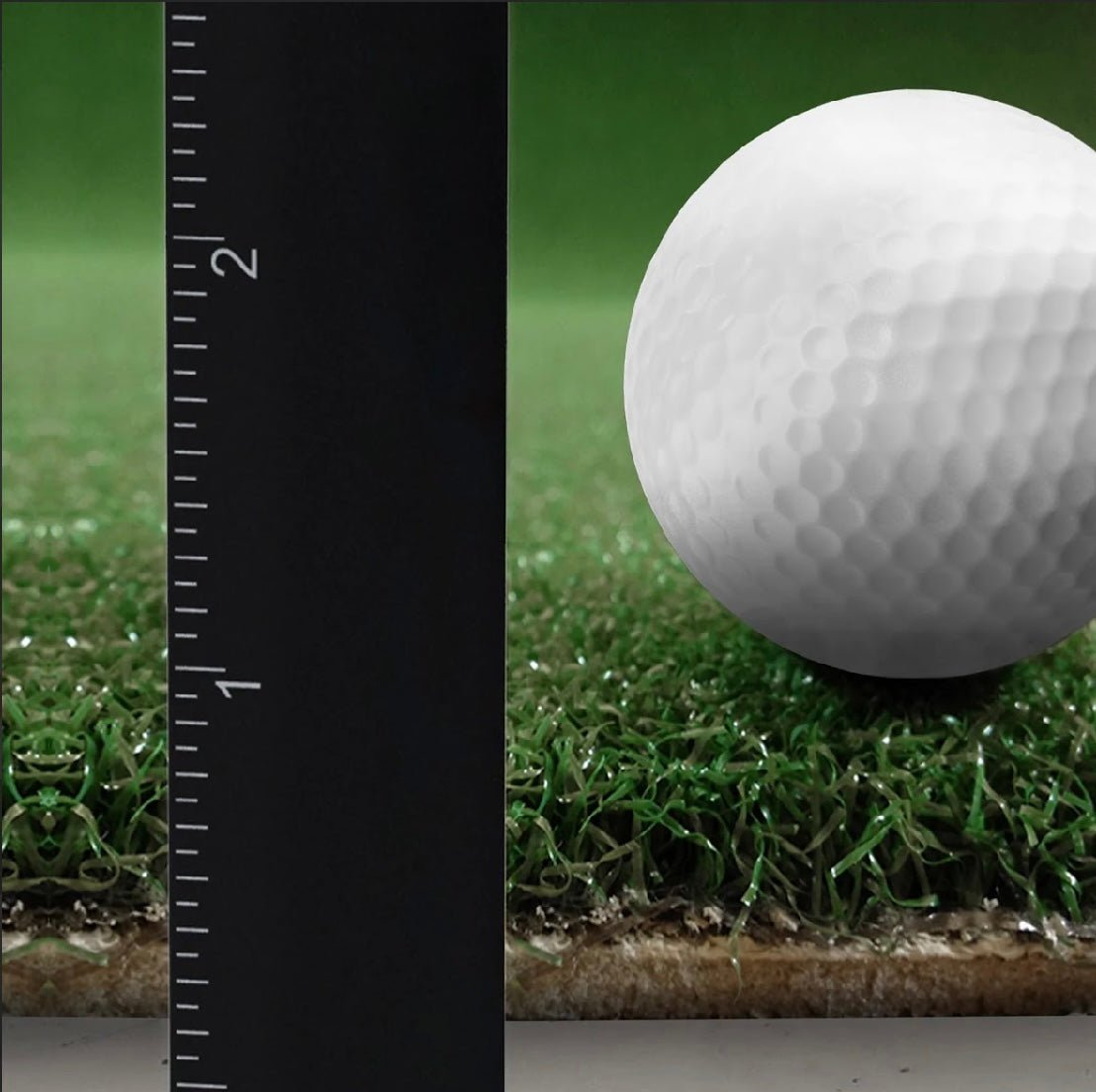 Close-up of The Net Return Pro Turf thickness with golf ball showing realistic surface texture - ALLBGT