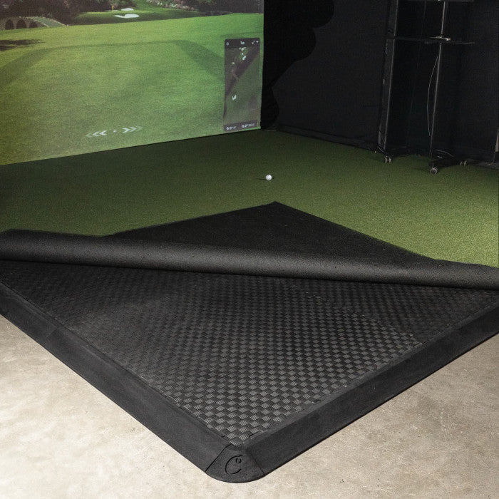Golf simulator setup with a screen displaying a golf course and Carl's Place golf room tile system