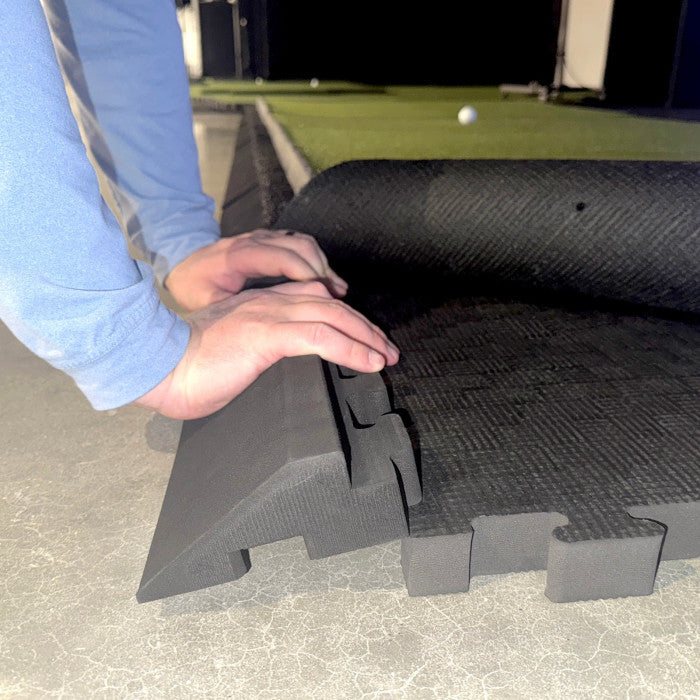 Person using Carl's Place floor edges interlocking foam mat on a concrete surface