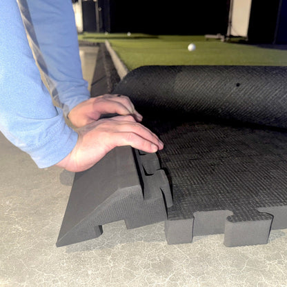 Person using Carl's Place floor edges interlocking foam mat on a concrete surface
