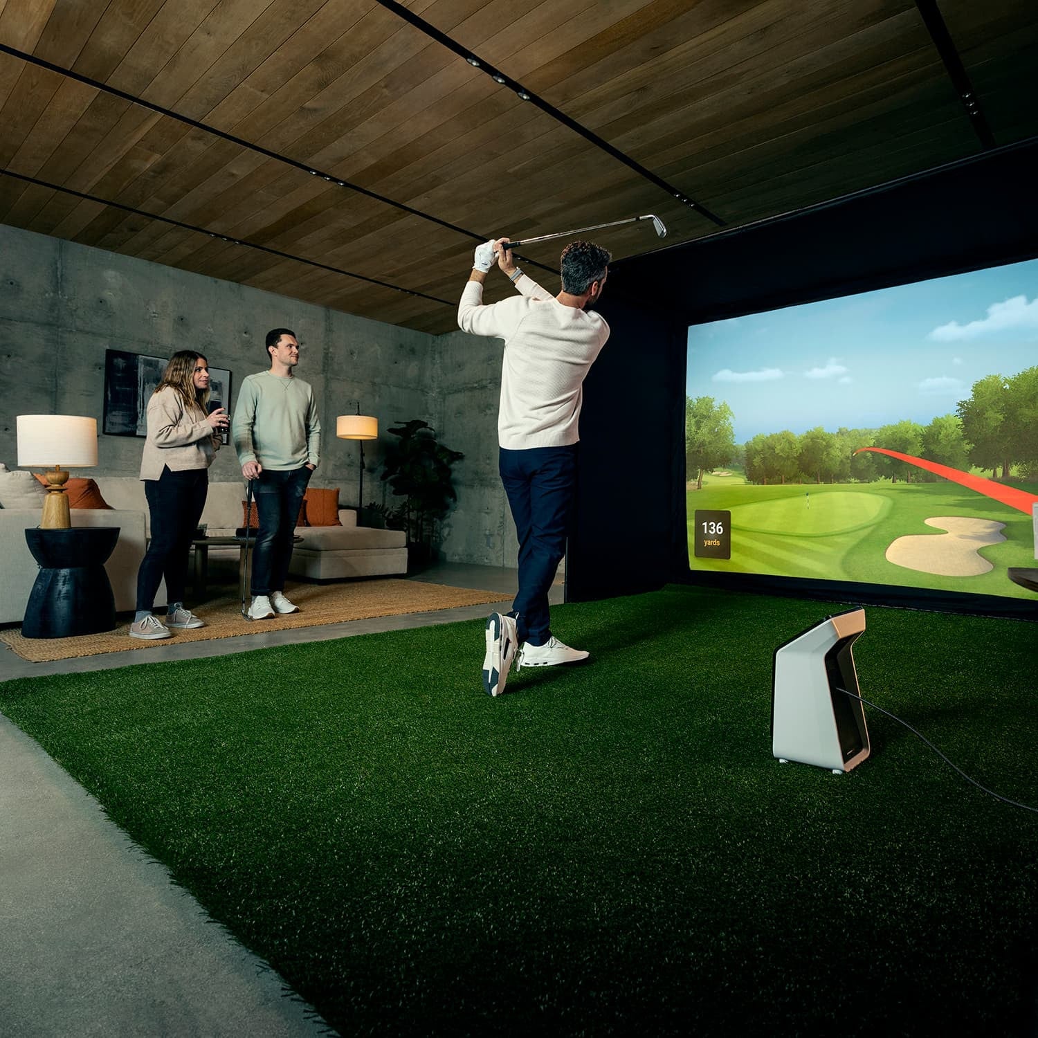 Garmin Approach R50 Launch Monitor in indoor golf simulator setup with golfer swinging - ALLBGT