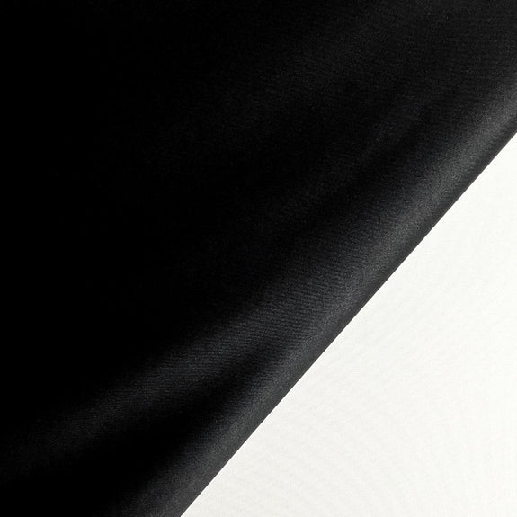 Opaque blackout fabric golf simulator screen material reducing light bleed and enhancing image clarity.