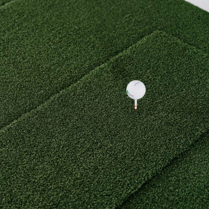 SIGPRO Softy Hitting Strip close-up with golf ball on tee demonstrating realistic turf feel and tee compatibility