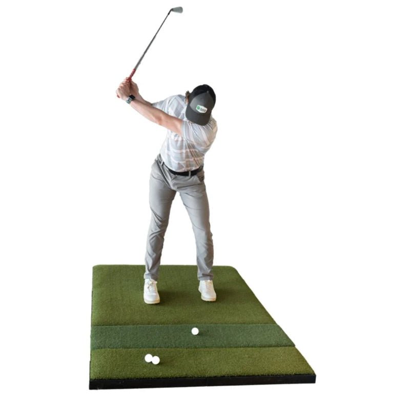 Golfer using SIGPRO Super Softy 4x6 golf mat indoor swing practice hitting strip simulator training